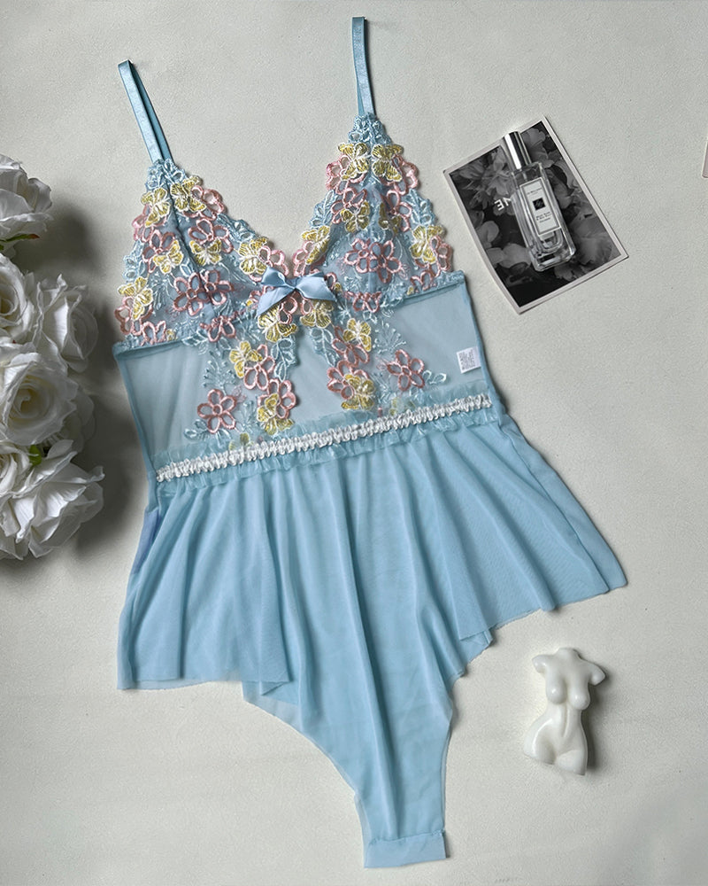 Blue floral lace bodysuit with multicolor embroidery, bow front, and ruffle skirt