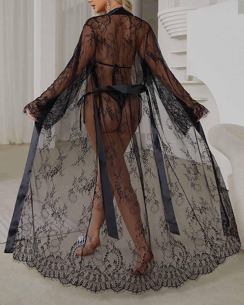 Black sheer lace robe dress with satin belt, open back, long draped sleeves.
