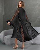Black nightgown with belt, sheer heart sleeves with feather trim, flowing side drape.