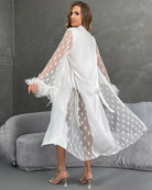 White nightgown with belt, sheer heart sleeves with feather trim, long draped back.