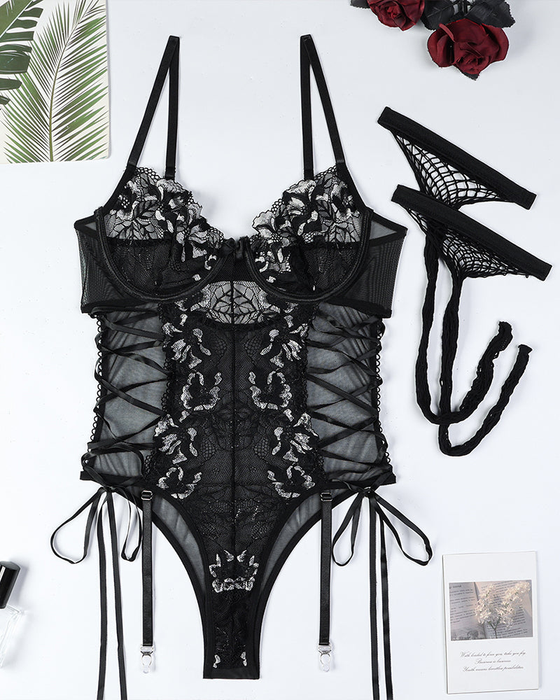 Black floral lace bodysuit with crisscross straps, lace-up sides, and garter bands