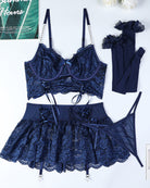 Dark navy lace bra, tie mini skirt, garter straps, and mesh stockings set (flat lay)