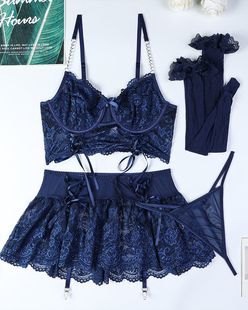 Dark navy lace bra, tie mini skirt, garter straps, and mesh stockings set (flat lay)