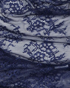 Navy lace fabric detail with floral pattern