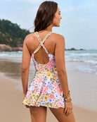 Back view of floral print swim dress with crisscross straps and open-back cutout