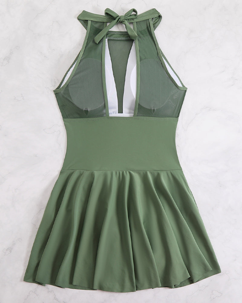 Plus size halter swim dress in sage green, open back strap and flared skirt.