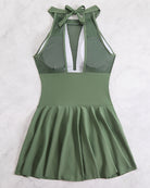 Plus size halter swim dress in sage green, open back strap and flared skirt.