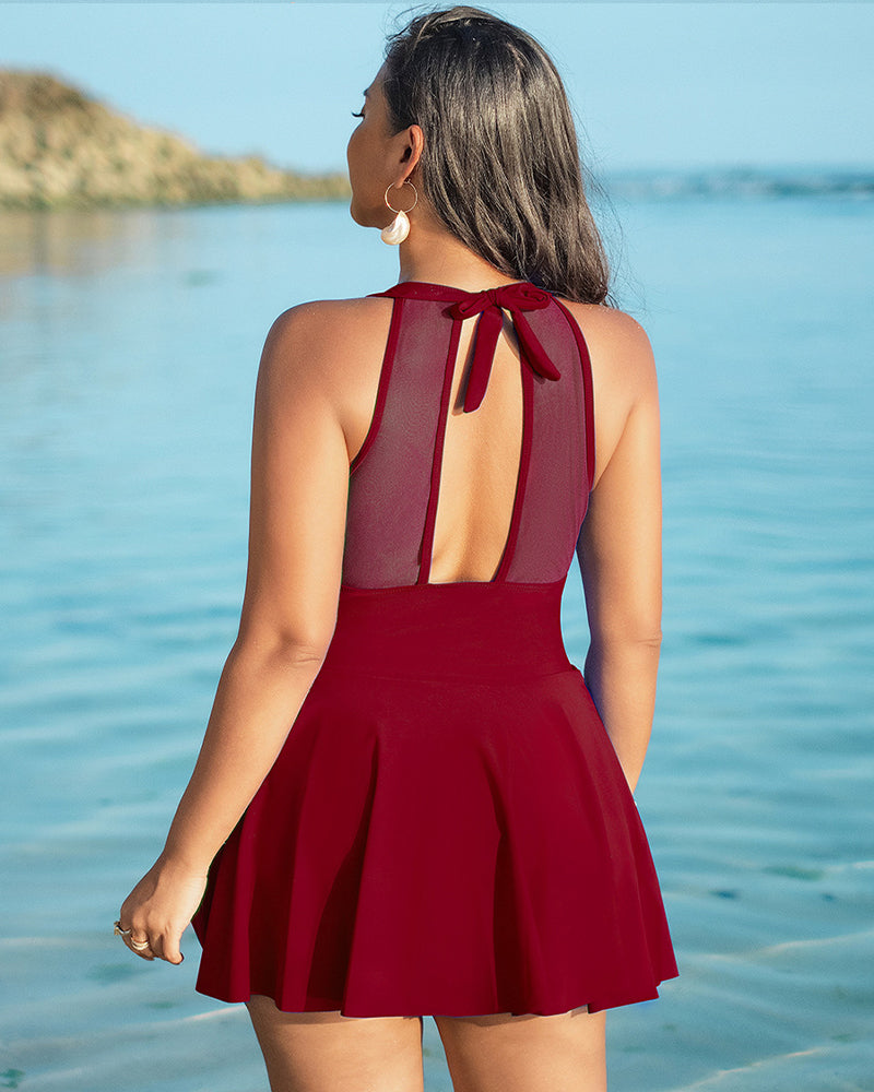 Back view dark red halter swim dress with open-back mesh panel and tie straps