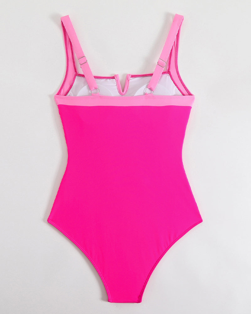 Pink push-up one-piece swimsuit with open V accent at bust and adjustable straps