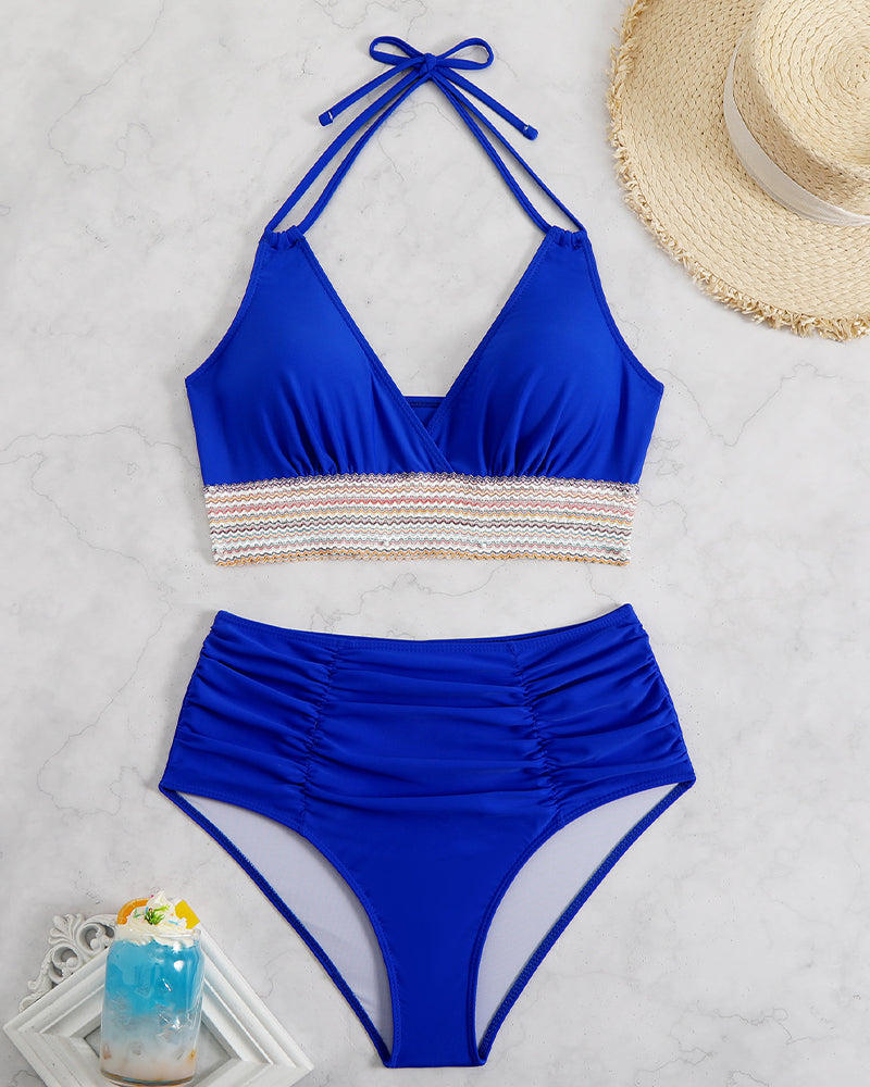 Royal blue halter bikini top and high-waist bottom set with multicolor striped waistband
