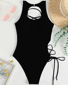 Black lace-up one-piece swimsuit with high neckline cutout and side lace-up ties