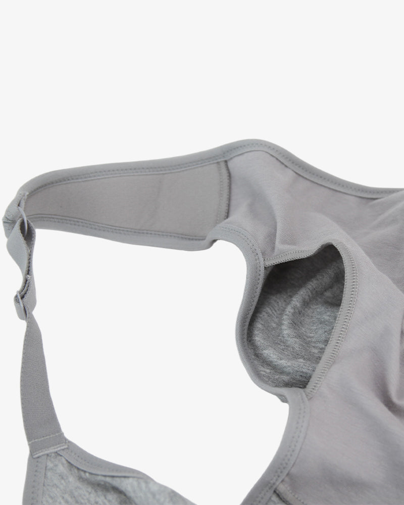 Grey bra close-up of front edge with stitched strap connection