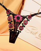 Low-waist triangle lace thong in black with pink floral lace appliques