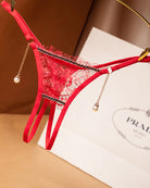 Red crotchless lace thong with pearl drop chains and black lace trim