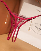 Pink crotchless lace thong with pearl drop chains and black lace trim