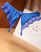 Blue crotchless lace low waist thong with scalloped lace trim and center flower detail