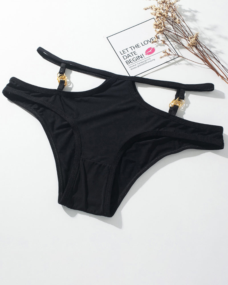 Black panties with thin straps and gold metal button accents