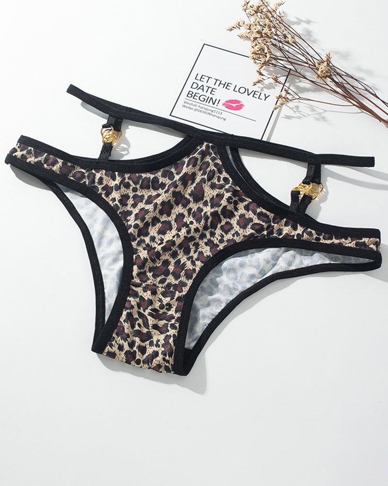 Leopard print panties with thin black straps and gold metal button accents