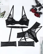 Black lingerie set flat lay: lace half-cup bra, garter belt, panties, and stockings.