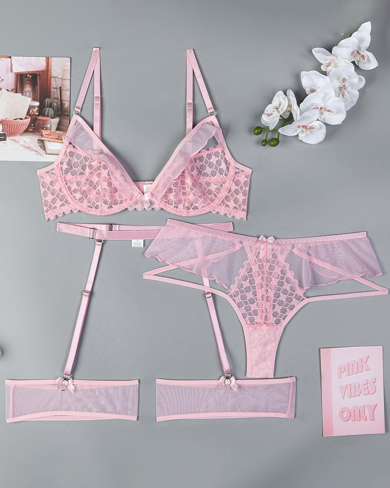Pink lingerie set flat lay: lace half-cup bra, garter belt, panties, and stockings.