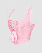Pink lace-up corset with floral jacquard, sweetheart neckline, and ribbon bows at straps