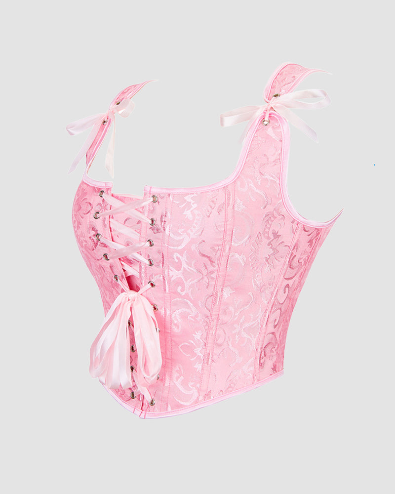 Pink lace-up corset with floral jacquard, sweetheart neckline, and ribbon bows at straps