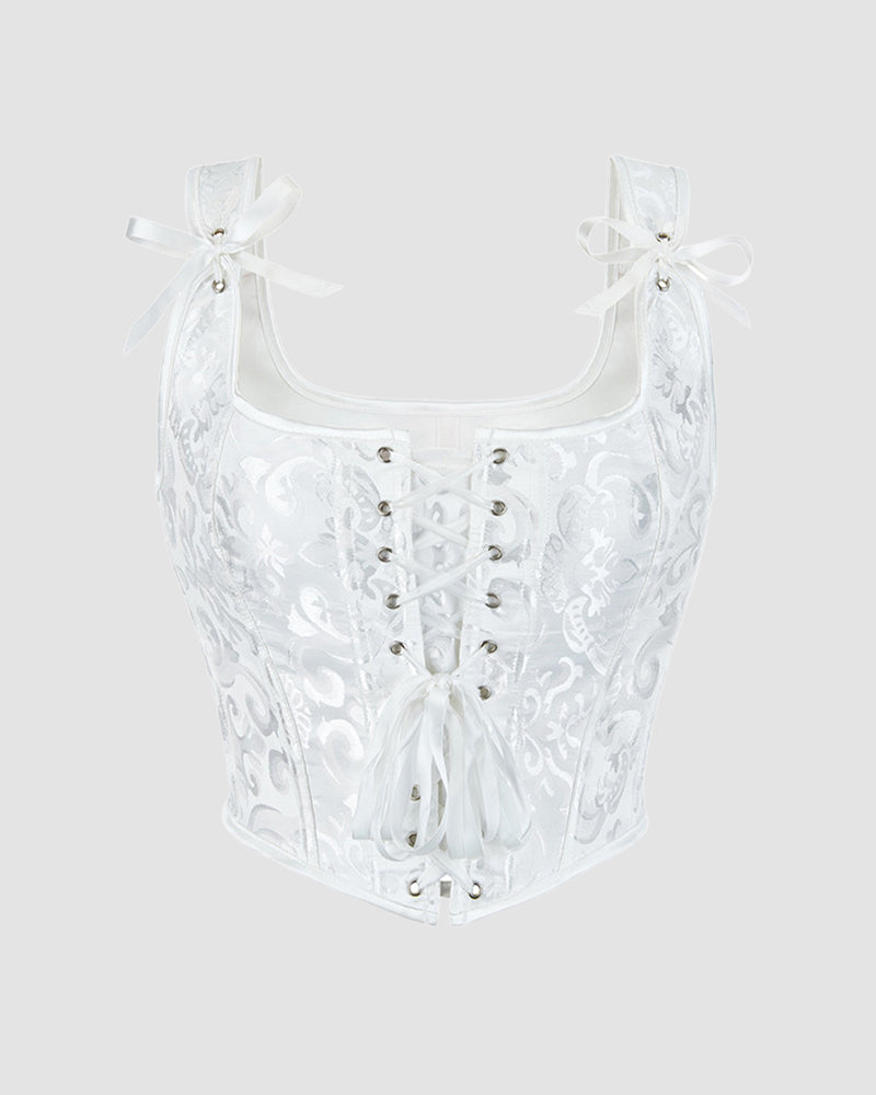 White corset with sweetheart neckline, floral jacquard, front lace-up, and ribbon bows