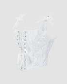 White lace-up corset with floral jacquard, sweetheart neckline, and ribbon bow details
