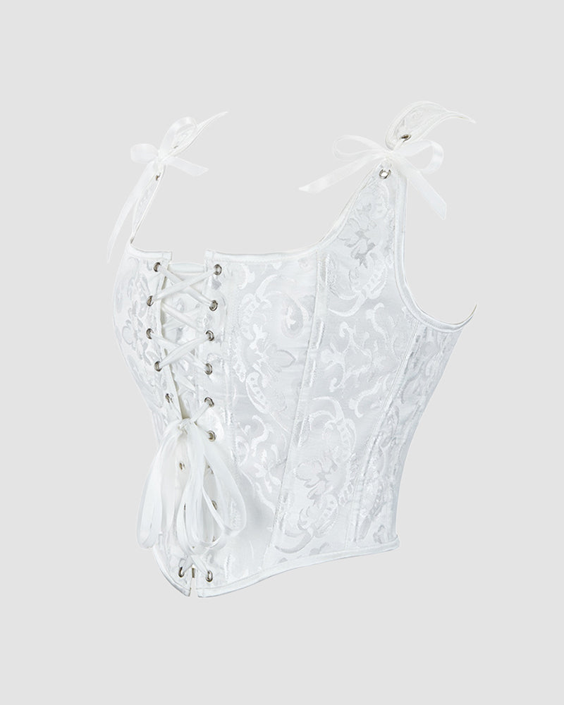 White lace-up corset with floral jacquard, sweetheart neckline, and ribbon bow details