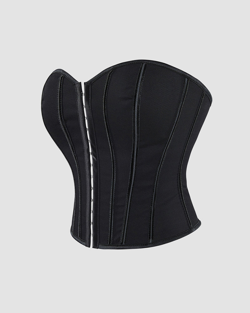 Black cotton corset back view with vertical boning and lace-up eyelets