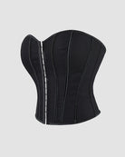 Black cotton corset back view with vertical boning and lace-up eyelets