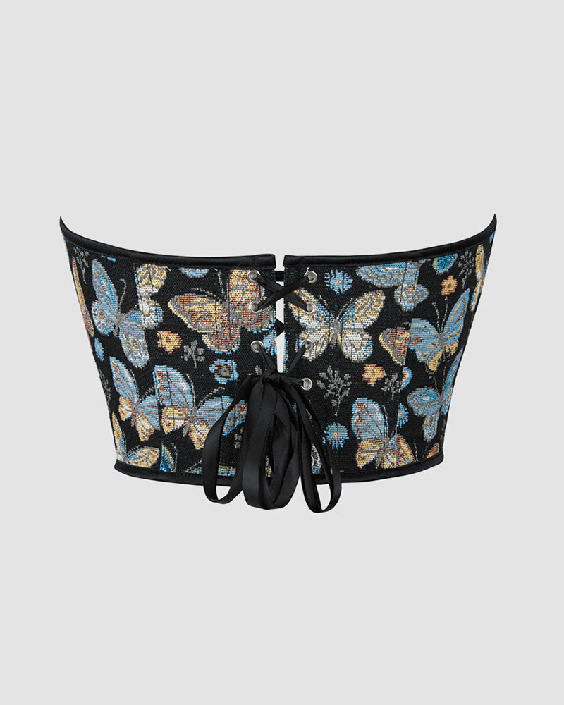 Back view of black butterfly-pattern corset with lace-up eyelets and black tie laces