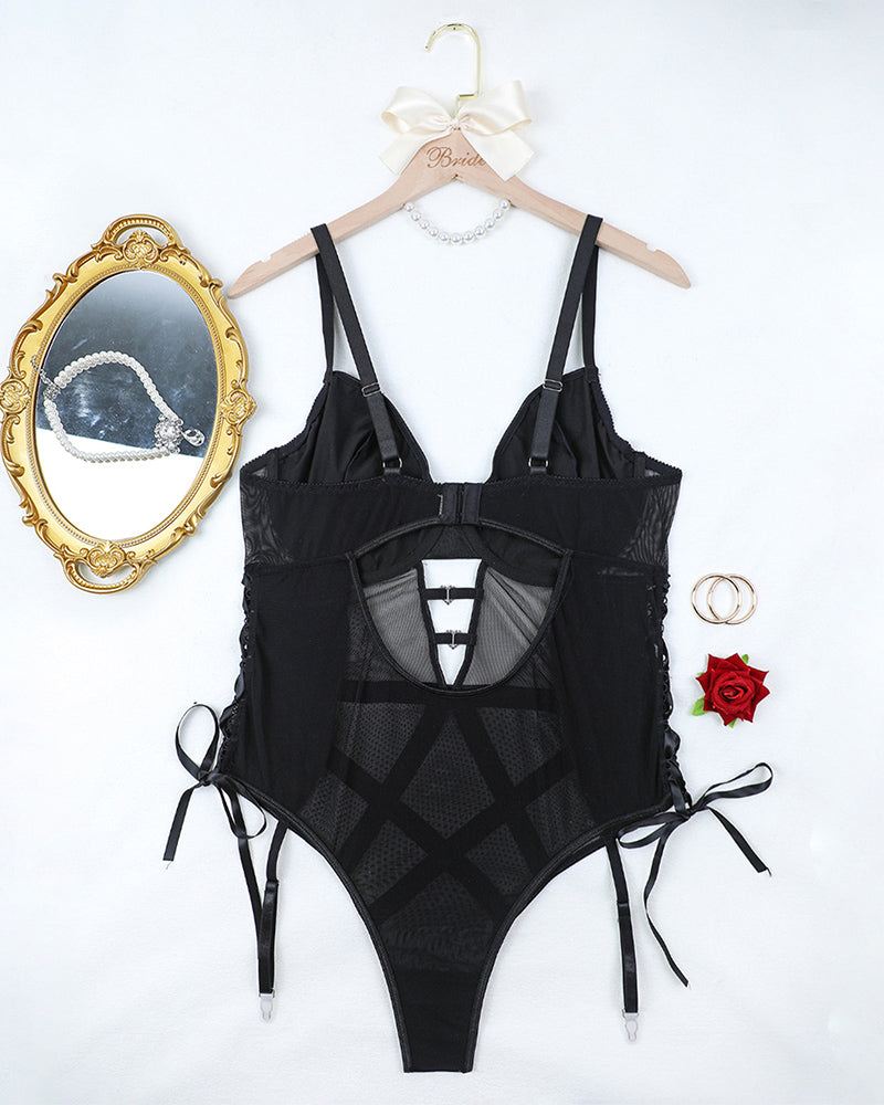 Black mesh and faux leather lingerie bodysuit on hanger with strappy garter ties