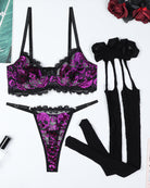 Purple skull-print lace bra, lace thong, garter straps, and black lace stockings