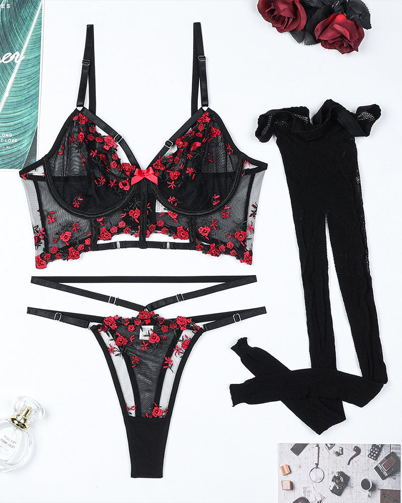 Wine red floral embroidered bra and thong set with fishnet stockings, flat lay
