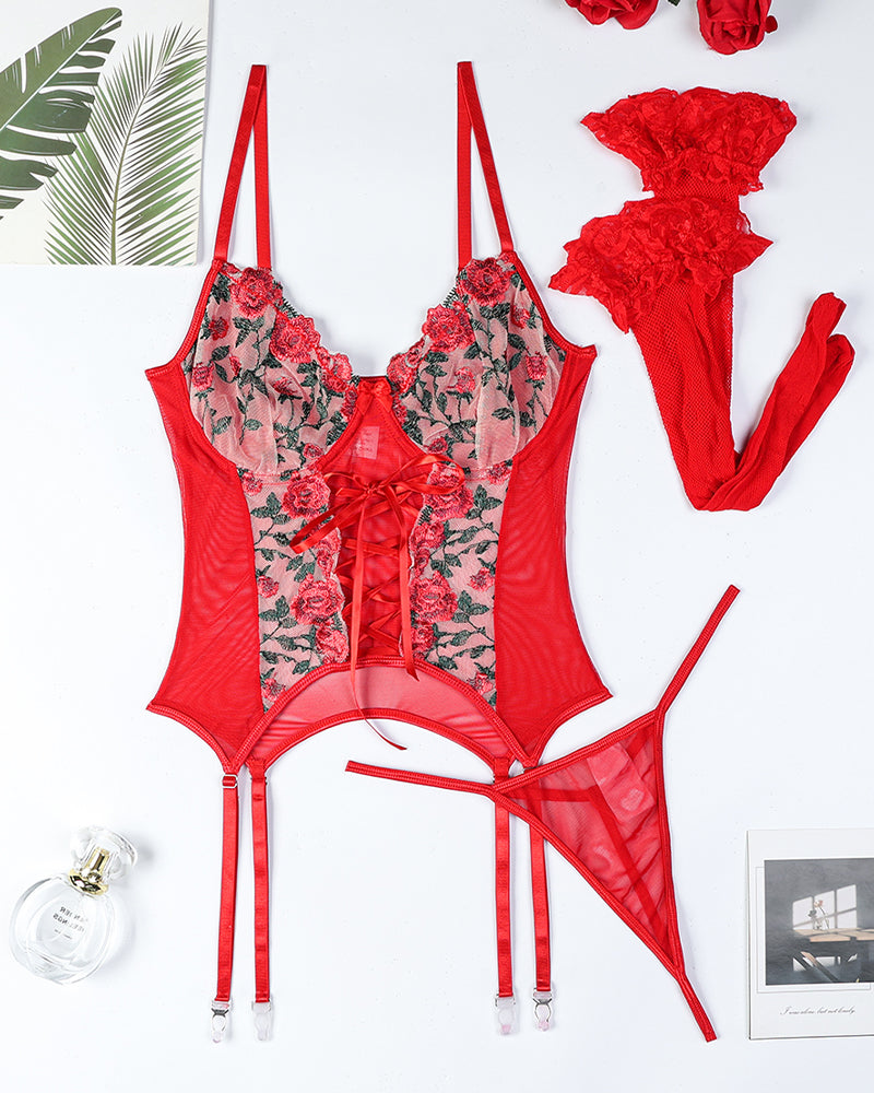 Red floral-embroidered lace bra set with garter straps and thong, flat lay pieces