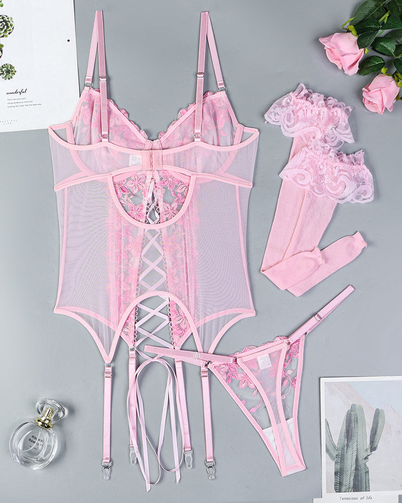 Pink floral embroidered lingerie set with lace trim, garter straps, and matching stockings