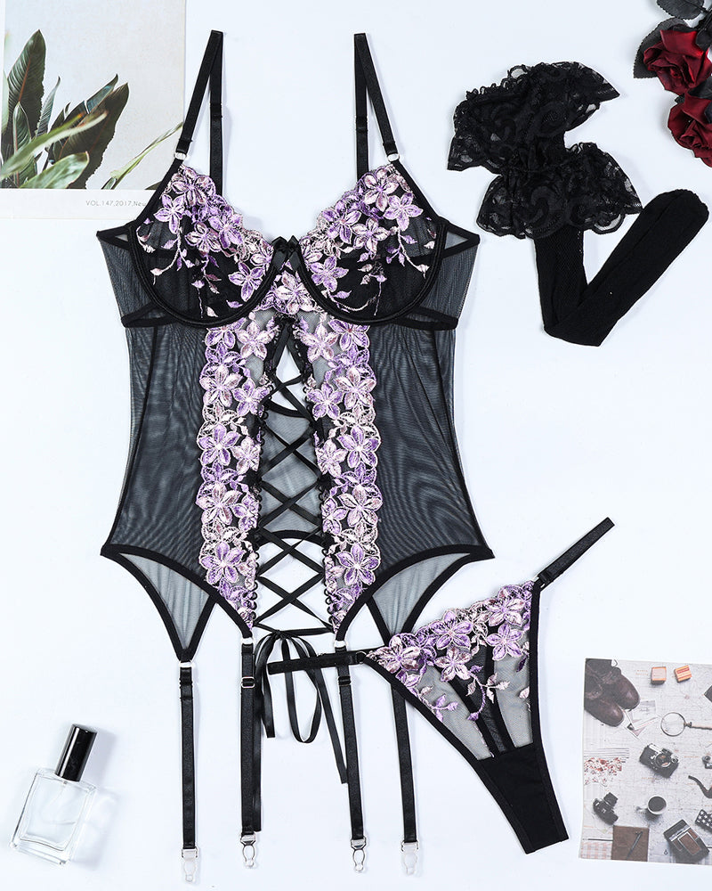 Black sheer lingerie set with purple floral embroidery, lace trim, and garter straps