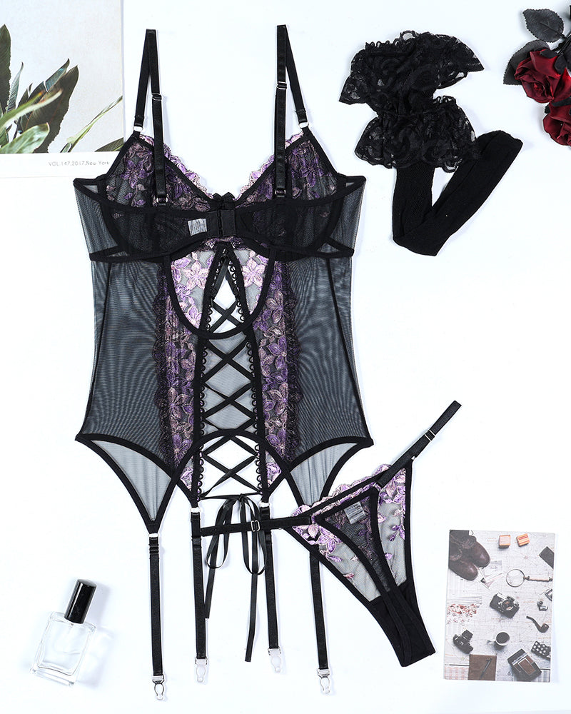 Black sheer lingerie set with purple floral embroidery, matching garters and thong-style bottom