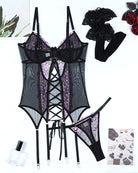 Black sheer lingerie set with purple floral embroidery, matching garters and thong-style bottom