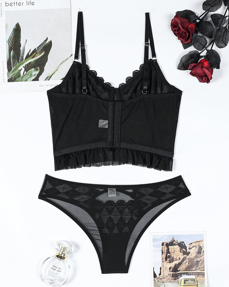 Black lace corset bra and thong set with cross-front heart trim and ruffle hem.
