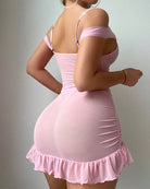 Pink satin slip dress with embroidered mesh bra cups, pearl straps, ruffled hem