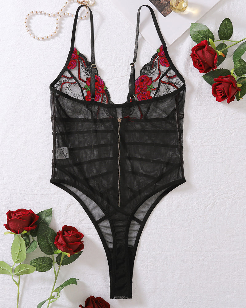 Black lace mesh bodysuit flat lay with red rose embroidery, V-neck straps, and front zip