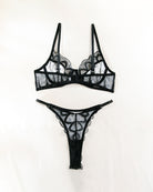Black lace bra and thong set with sheer mesh panels and scalloped lace trim