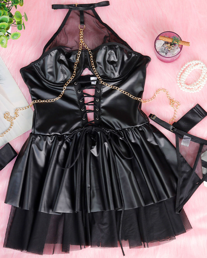 Black halterneck mesh mini dress flat lay with lace-up corset front and satin pleated skirt.