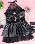 Black halterneck mesh mini dress flat lay with lace-up corset and layered tulle hem.