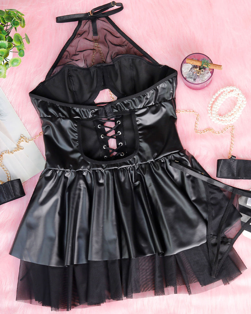 Black halterneck mesh mini dress flat lay with lace-up corset and layered tulle hem.