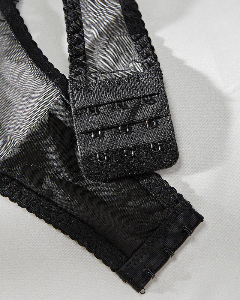 Black mesh bodysuit back closure with adjustable hook-and-eye band and lace edge