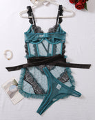 Turquoise mesh bra and thong lingerie set with black lace accents and ruffled skirt