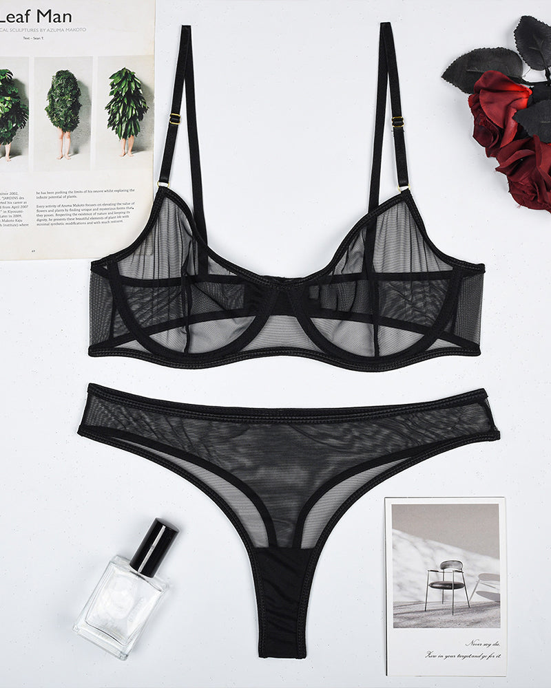 Black sheer mesh underwire bra and thong panty set, flat lay